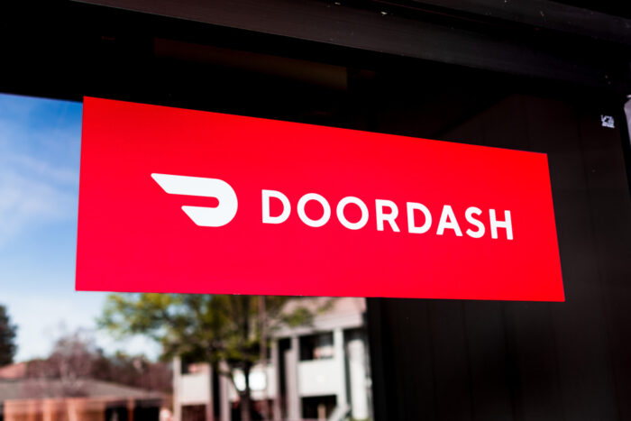 Close up of Doordash logo and symbol displayed at the entrance to one of their offices.