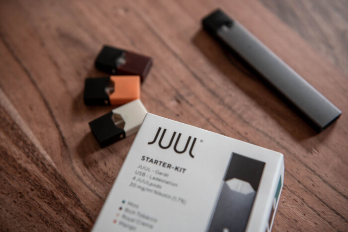 A JUUL Starter Kit on a table.