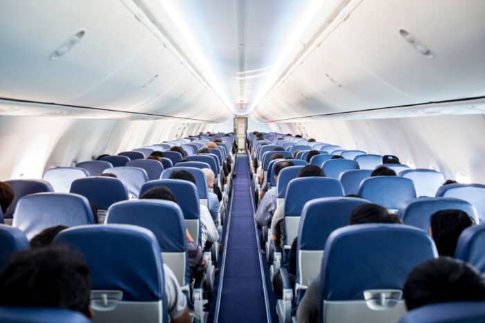 Passengers traveling by a plane, shot from the inside of an airplane.