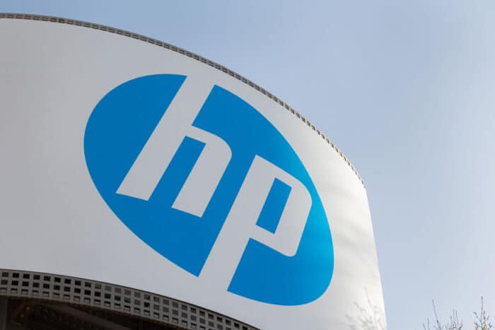 Close up of HP signage on an exterior building against a blue sky.