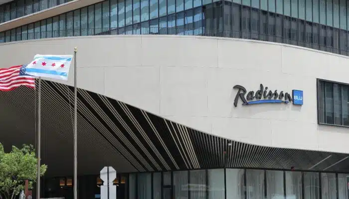 People walk past Radisson Blu hotel 