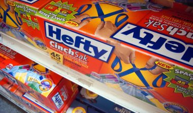 Boxes of Reynolds Hefty trash bags are seen on a supermarket shelf.
