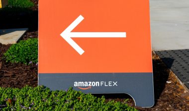 Amazon Flex sign directs independent contractors to delivery services at Amazon Flex Distribution Center.