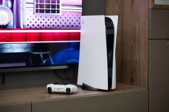 The brand new Sony PlayStation 5 gaming console with DualSense controller near tv screen at home ready to use, representing the Sony class action.