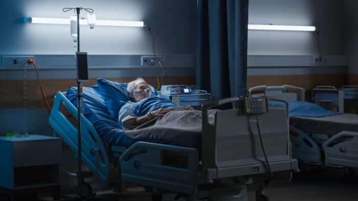 Portrait of Elderly Man Wearing Oxygen Mask Resting in Bed, Struggling to Recover after Covid-19 - holyoke soldiers home lawsuit