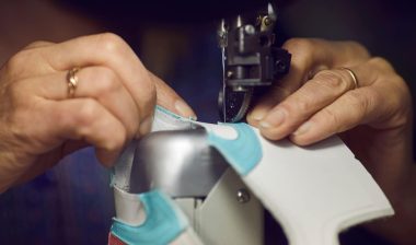 Shoe factory worker making shoes. Converse lawsuit