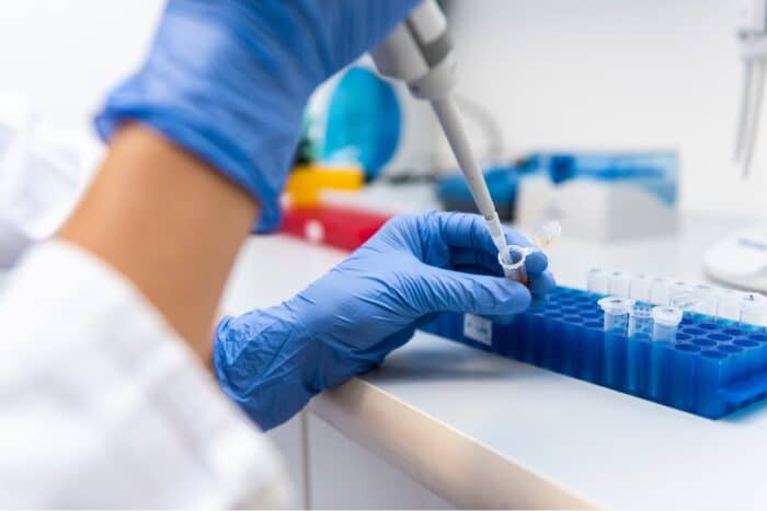 Lab worker performing tests with special equipment. Precision Toxicology lawsuit