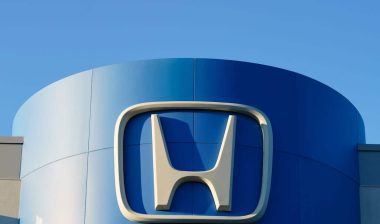 Close up of Honda signage against a blue sky.