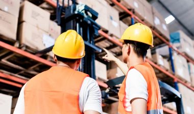 Worker team taking inventory in logistics warehouse