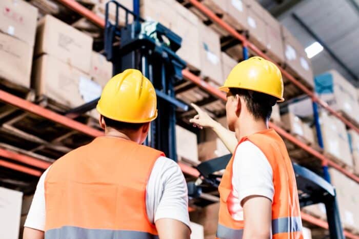 Worker team taking inventory in logistics warehouse - Avent Group, Tigers Global Logistics settlement
