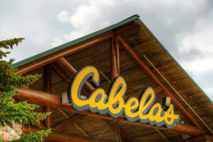 Close up of exterior Cabela's signage against a cloudy sky - tent recall