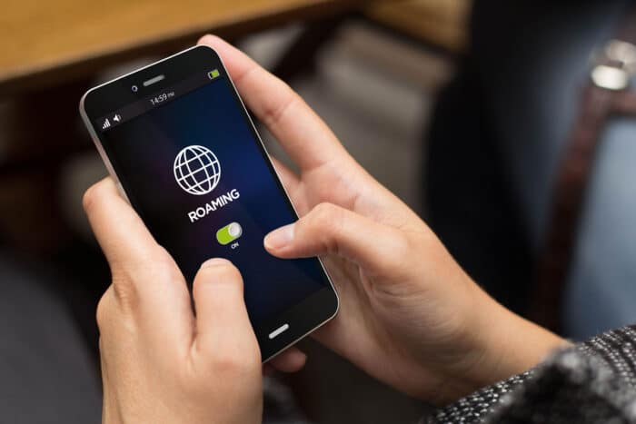 Girl using a digital generated phone with roaming on the screen.