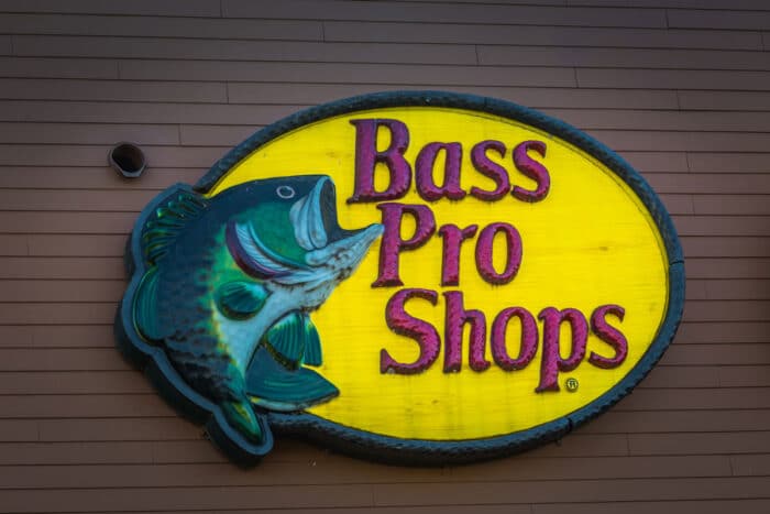A Bass Pro Shops Logo outdoor wall sign - class action, socks, lifetime warranty