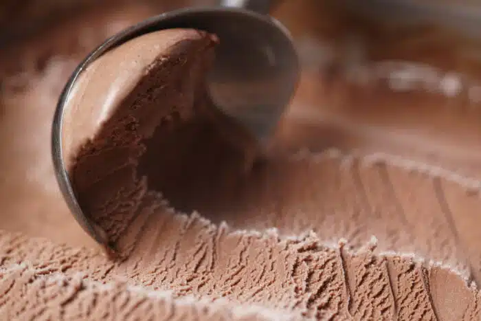 scooping chocolate ice cream close up shot, shallow focus