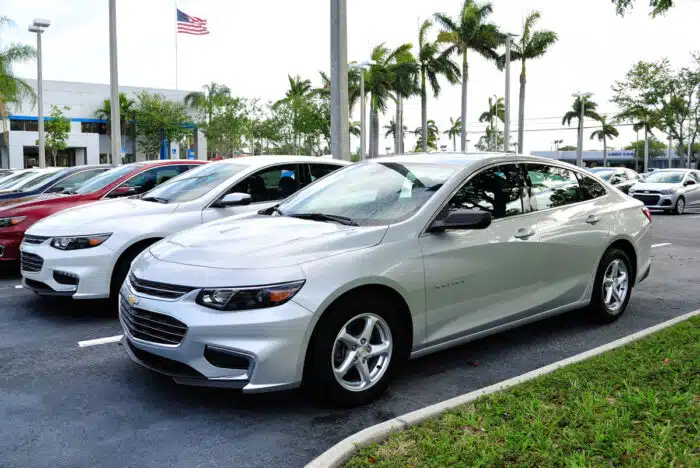 New Chevrolet Malibu lined up on the lot ready to be sold.