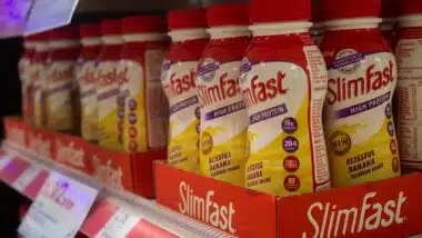 Slim Fast products on a shelf in a pharmacy store.