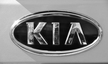Close up of old Kia emblem on a vehicle.