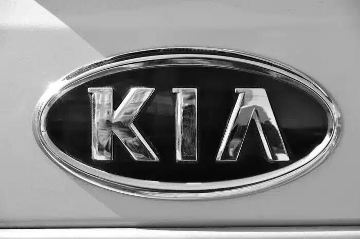 Close up of old Kia emblem on a vehicle.