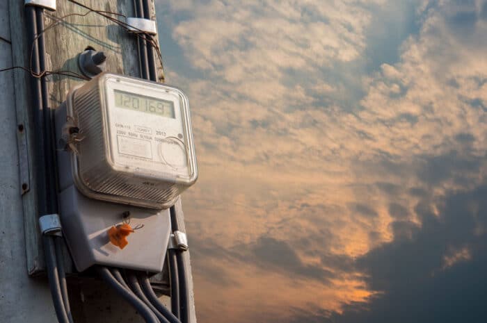 Electrical meter box against a sunset sky - palmco power energy settlement