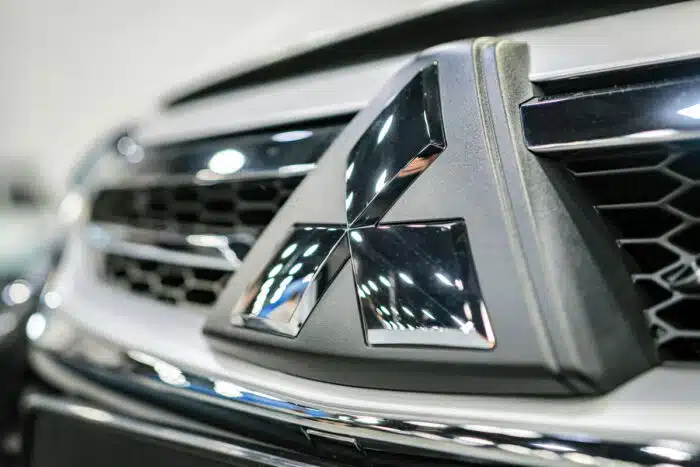 Mitsubishi Motors logo on the radiator grille close up.