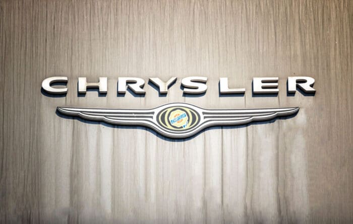 Chrysler signage hanging against a wood wall.