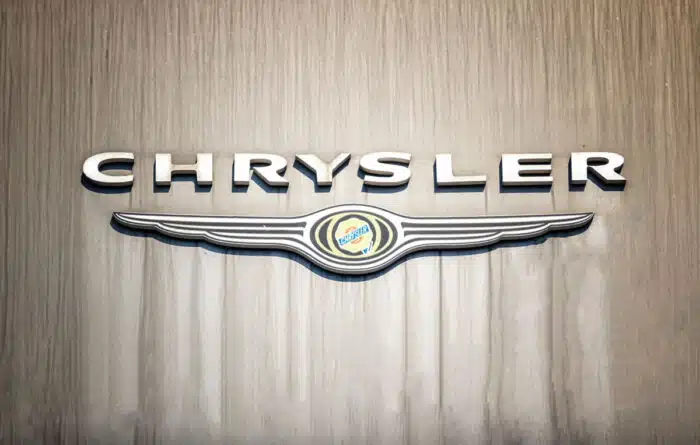 Chrysler signage hanging against a wood wall.