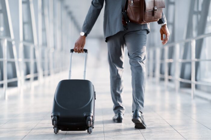 Baggage man, walking through passenger boarding bridge, concept of action lawsuit investigation for unpaid travel time