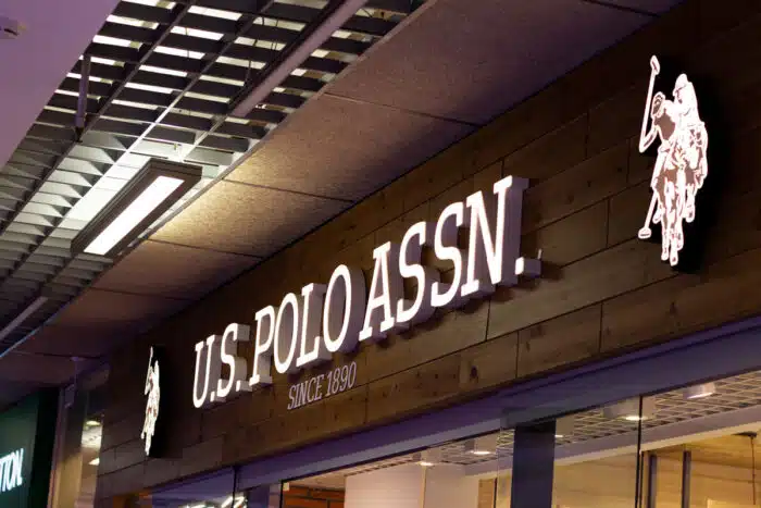 Close of up US Polo signage inside of a mall - fake sale prices