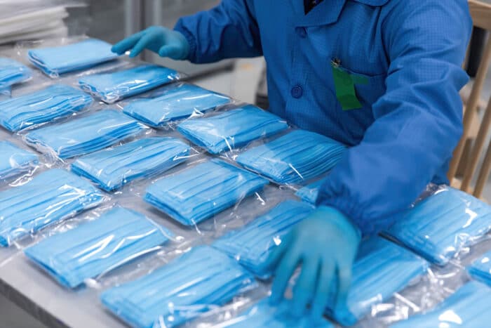 Medical mask worker organizing face masks.