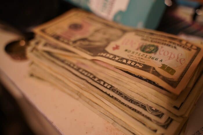 Stack of United States currency, server tips, shallow depth of field