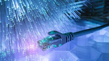 Network cables with fiber optical technology background. Broadband internet concept.