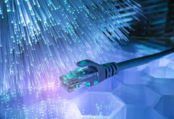 Network cables with fiber optical technology background. Broadband internet concept.