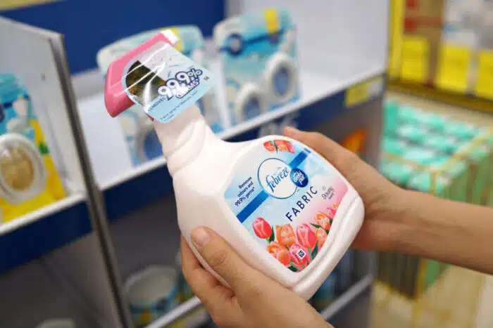 Female hand holding the new Febreze fabric freshener spray bottles.