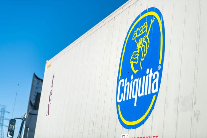 Highway road in Virginia with cargo transportation truck on interstate highway road and advertisement sign closeup for Chiquita bananas - brands, class action lawsuit