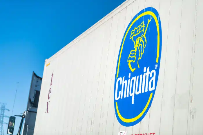 Highway road in Virginia with cargo transportation truck on interstate highway road and advertisement sign closeup for Chiquita bananas - brands, class action lawsuit