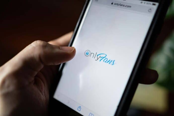 Close up of the Only Fans loading page on a smartphone screen - lawsuits, pornography industry, Facebook, meta