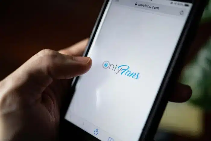 Close up of the Only Fans loading page on a smartphone screen - lawsuits, pornography industry, Facebook, meta