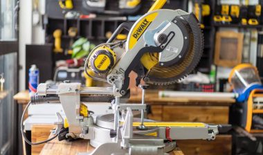 DEWALT sliding compound miter saw on wooden teble at carpenter workplace.