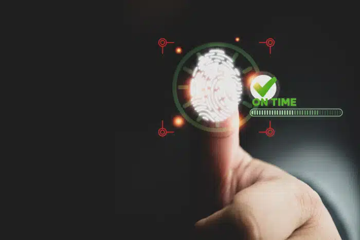 Man use a fingerprint for scan on visualizer screen to check in with on time used to track and monitor when employees start work - fingerprint class action lawsuit, bipa, jame roll settlement
