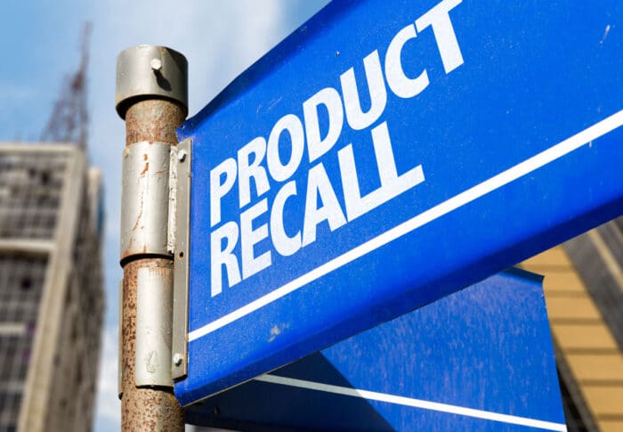 Product Recall written on a blue road sign.