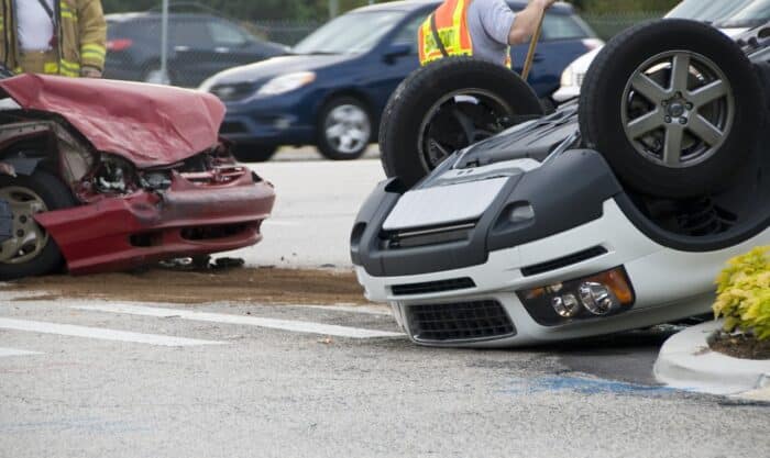 Rollover Vehicle Accident at Busy Intersection With Emergency Personnel to Assist, total loss concept