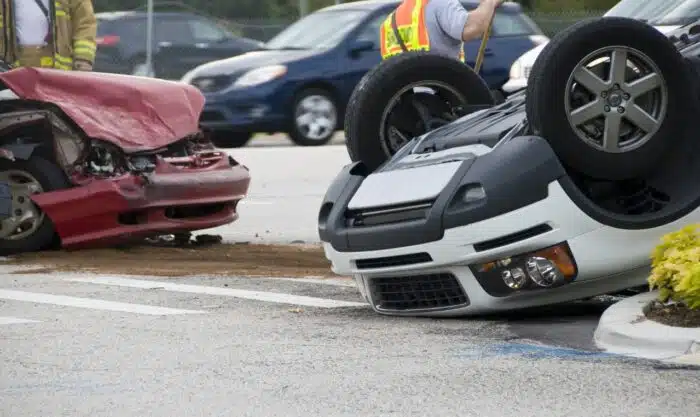 Rollover Vehicle Accident at Busy Intersection With Emergency Personnel to Assist, total loss concept