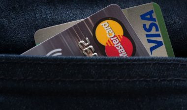 Mastercard and Visa credit cards in jeans pocket.