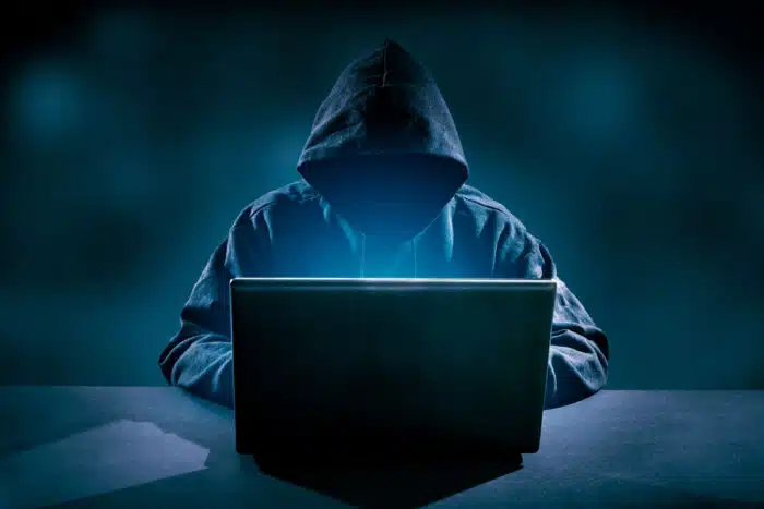 Hacker using laptop. Hacking the Internet.
