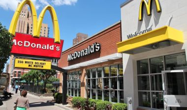 People walk by McDonald's restaurant in Chicago. mcdonald's settlement over BIPA violation
