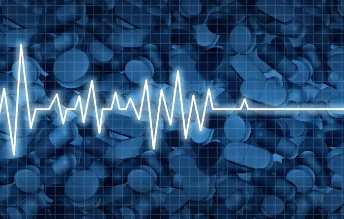 Opioid death crisis and prescription painkiller addiction epidemic concept as an ekg or ecg monitor life flatline over pills as a medical addict problem as a 3D illustration elements.