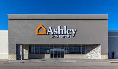 Ashley HomeStore storefront against a blue sky.