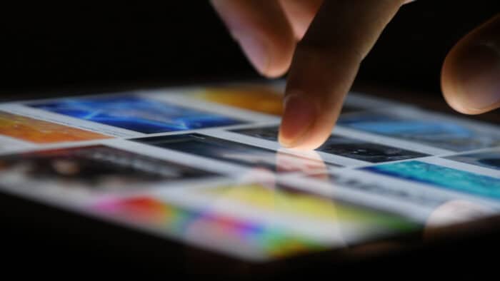 Closeup of hand and tablet - Overtime Sports website
