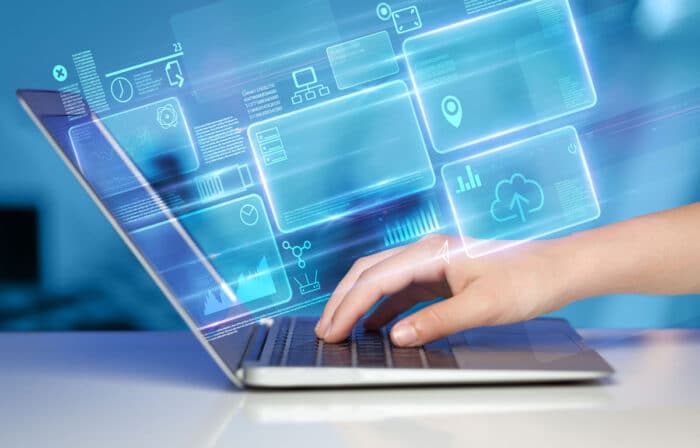 Close up of a persons hands using a laptop with a data tracking overlay.
