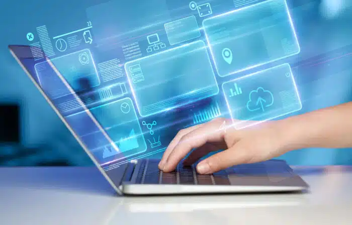 Close up of a persons hands using a laptop with a data tracking overlay.